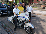 A photograph featuring the two racing drivers, the police officers, the Mayor of the City of Hradec Králové, Mr Divíšek, and the Director of the Hradec Králové Metropolitan Police, Mr Hloušek