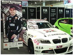 Součástí expozice stánku FIA ETCC na výstavě ESSEN MOTOR SHOW je i vítězné BMW 320si Petra Fulína a roll up Michala Matějovského z týmu Křenek Motorsport